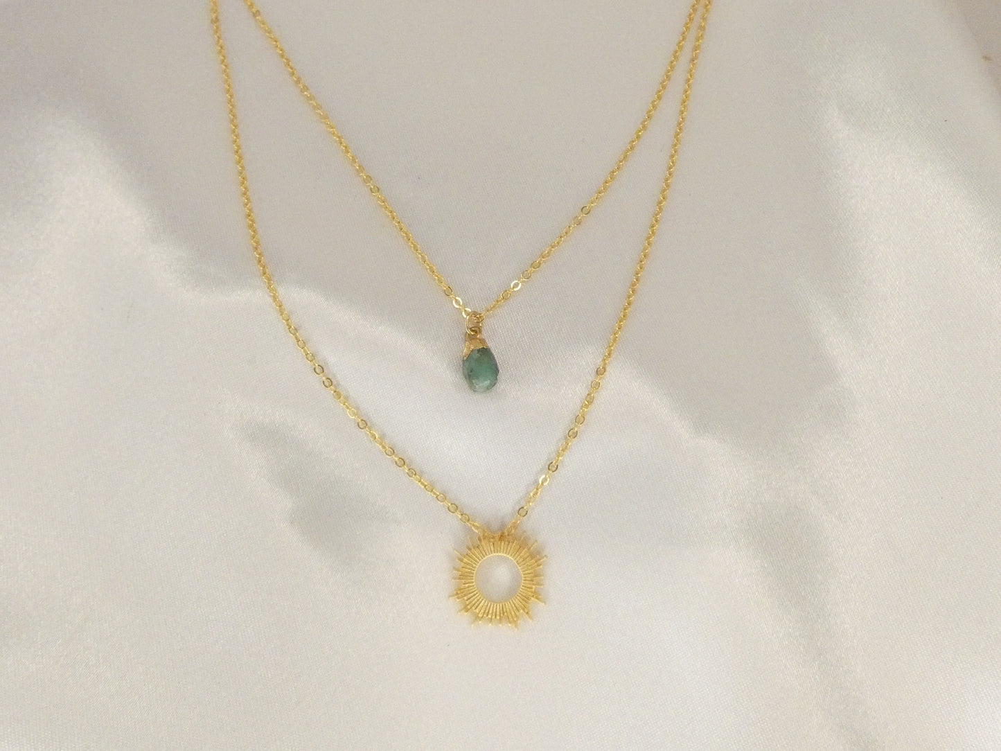 Double necklace with Emerald and sun