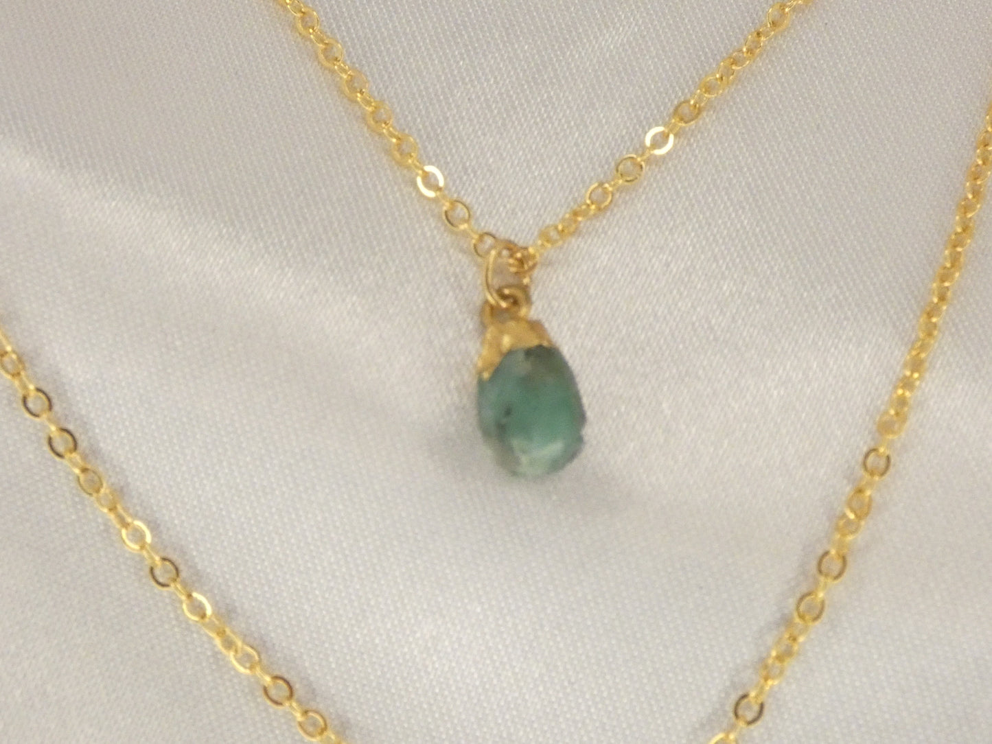 Double necklace with Emerald and sun