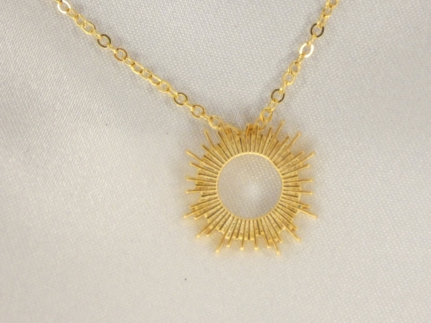 Double necklace with Emerald and sun